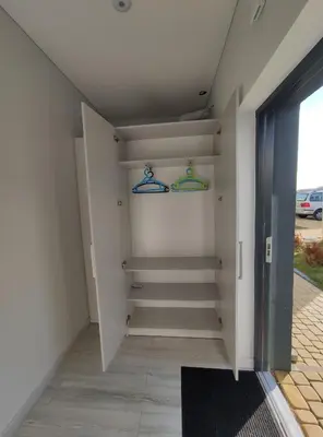 a walk in closet with hangers in a room at K-Town - Apartments ViaBaltic Kaunas in Kaunas
