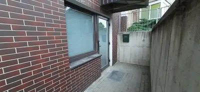 a brick building with a window on the side of it at Elite Flats One bedroom in Utena