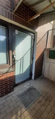 a garage door with a gate in a brick building at Elite Flats One bedroom in Utena