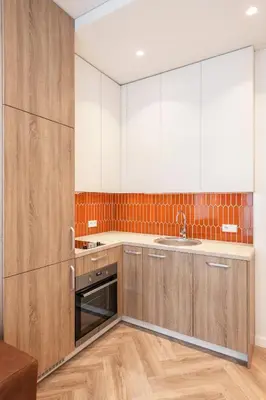 a kitchen with wooden cabinets and a sink at Angel House Vilnius, Old Town 6 in Vilnius