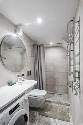 a bathroom with a toilet and a sink and a washing machine at Angel House Vilnius, Old Town 6 in Vilnius