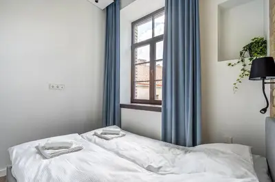 a bedroom with a bed and a window with towels on it at Angel House Vilnius, Old Town 6 in Vilnius