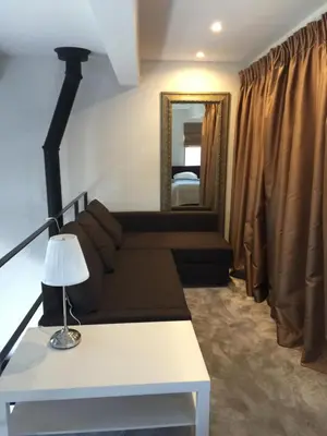 a living room with a couch and a mirror at Loft 65 Panoramic View in Vilnius