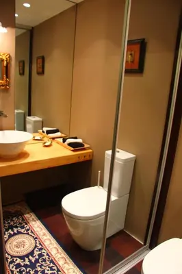 a bathroom with a toilet and a sink at Loft 65 Panoramic View in Vilnius
