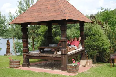 a man and a woman laying in a gazebo at Sodyba Ciciriai in Vėdariai