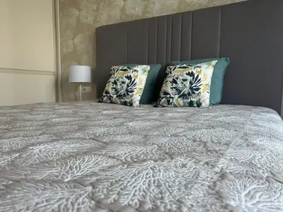 a bedroom with a large bed with two pillows at Blue Peony in Druskininkai