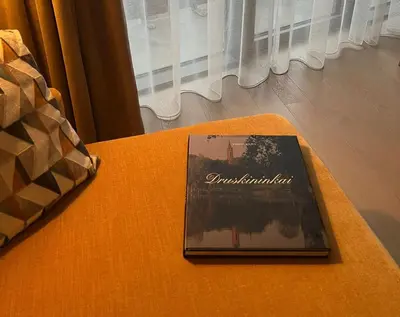 a book sitting on top of a table at Blue Peony in Druskininkai