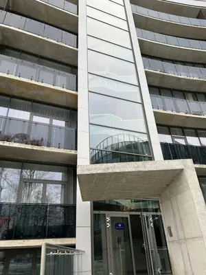 a building with a revolving door in front of it at Blue Peony in Druskininkai