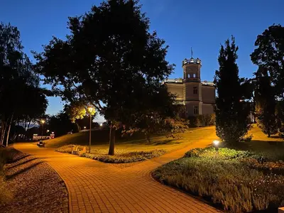 a building with a clock tower on top of it at Blue Peony in Druskininkai