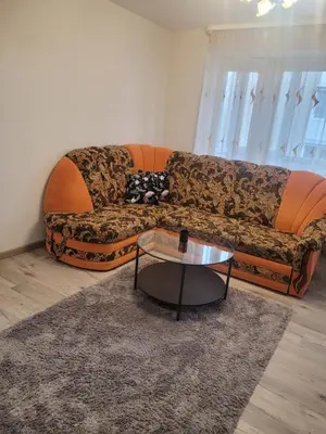 a living room with a couch and a coffee table at Maironio Apartamentai in Radviliškis