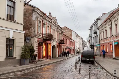a van parked on a cobblestone street with buildings at Lovely apartment Traku str. in Vilnius