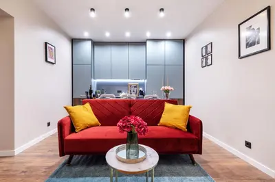 a living room with a red couch and a table at Lovely apartment Traku str. in Vilnius