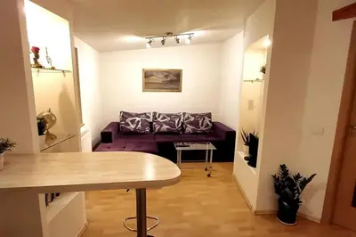 a living room with a couch and a table at Laisves Apartment Kaunas in Kaunas