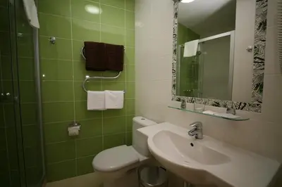 a bathroom with a sink and a toilet and a mirror at Medical SPA 