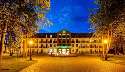 a building with a clock on top of it at night at Medical SPA 