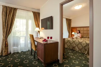 a woman sitting on a bed in a hotel room at Medical SPA 