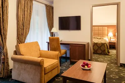 a hotel room with a chair and a desk and a bed at Medical SPA 