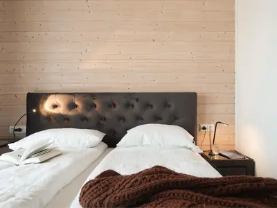 a bedroom with a large bed with white sheets and pillows at Palaima Hotel Anykščiai in Anykščiai