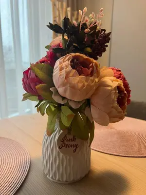 a bouquet of flowers in a vase on a table at Pink Peony in Druskininkai