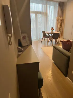 a living room with a couch and a table at Pink Peony in Druskininkai