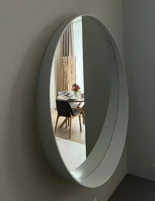 a mirror on a wall with a table in a room at Pink Peony in Druskininkai