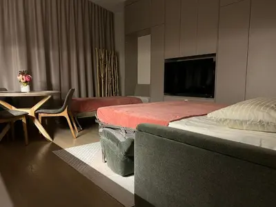 a hotel room with a bed and a tv at Pink Peony in Druskininkai