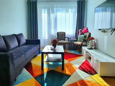 a living room with a couch and a table at Lovely 2-bedroom Flat in Šiauliai in Šiauliai
