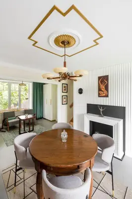 a living room with a wooden table and chairs at Entire interwar Villa Grabyte by pine forest on the bank of the river- 8min by car from old town in Kaunas