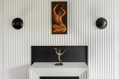 a room with a fireplace with a picture on the wall at Entire interwar Villa Grabyte by pine forest on the bank of the river- 8min by car from old town in Kaunas