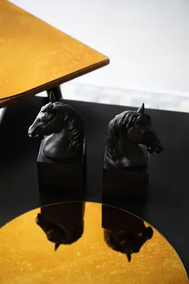 two statues of two horses on a table at Entire interwar Villa Grabyte by pine forest on the bank of the river- 8min by car from old town in Kaunas