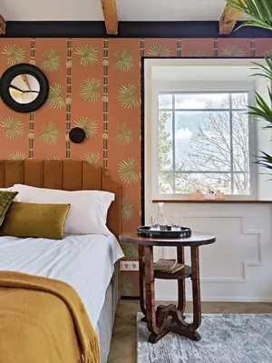 a bedroom with a bed and a table next to a window at Entire interwar Villa Grabyte by pine forest on the bank of the river- 8min by car from old town in Kaunas