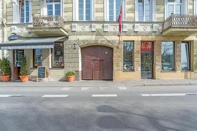 a building with a brown door on a street at Vilnius Old Town apartment in Vilnius