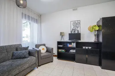 a living room with a couch and a tv at Jaukus ir kokybiškas butas Panevėžio centre in Panevėžys
