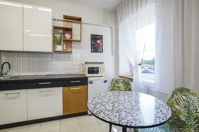 a kitchen with a table and a small table with chairs at Jaukus ir kokybiškas butas Panevėžio centre in Panevėžys