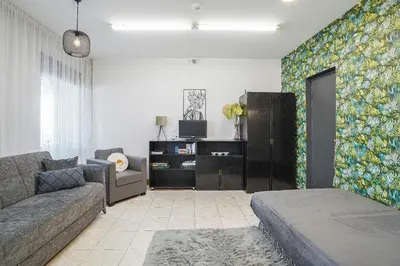 a living room with a couch and a tv at Jaukus ir kokybiškas butas Panevėžio centre in Panevėžys