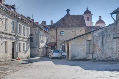 a car parked in an alley in an old city at Mini apartament by Town hall, self chek-in in Vilnius