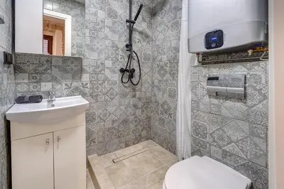 a bathroom with a toilet and a sink at Mini apartament by Town hall, self chek-in in Vilnius