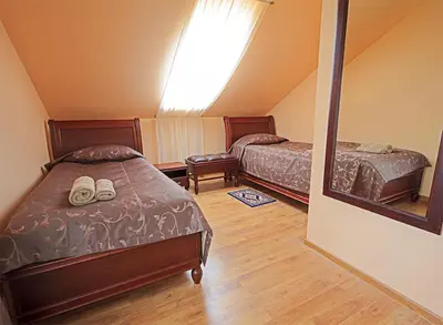 a bedroom with two beds and a window at El Arm El in Druskininkai
