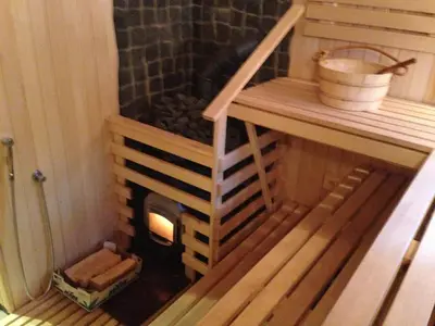 a sauna with a wood stove in a room at El Arm El in Druskininkai