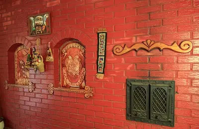 a red brick wall with a sign on it at El Arm El in Druskininkai