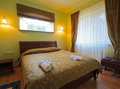 a bedroom with a bed with two towels on it at El Arm El in Druskininkai