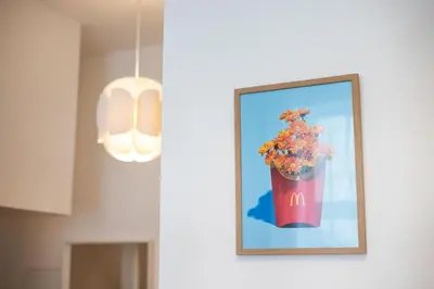 a picture of a vase of flowers on a wall at #stayhere - Modern & Central Studio Apartments in Vilnius
