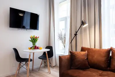 a living room with a couch and a table at #stayhere - Modern & Central Studio Apartments in Vilnius