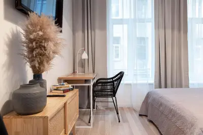 a bedroom with a desk and a chair and a bed at #stayhere - Modern & Central Studio Apartments in Vilnius