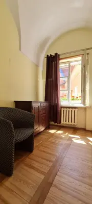 a living room with a couch and a window at ReHouse Stikliu 4 in Vilnius