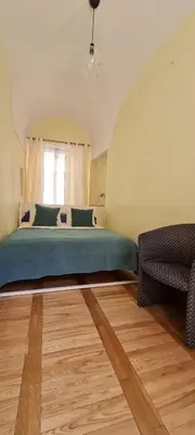 a bedroom with a large bed and a window at ReHouse Stikliu 4 in Vilnius