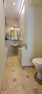 a bathroom with a white toilet and a sink at ReHouse Stikliu 4 in Vilnius