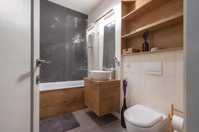 a bathroom with a toilet and a sink and a shower at Pilies Street Exclusive Apartment by Reside Baltic in Vilnius