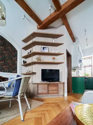 a living room with wooden stairs and a flat screen tv at Luxury OldTown Free Parking in Vilnius