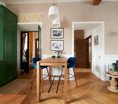 a dining room with a wooden table and blue chairs at Luxury OldTown Free Parking in Vilnius